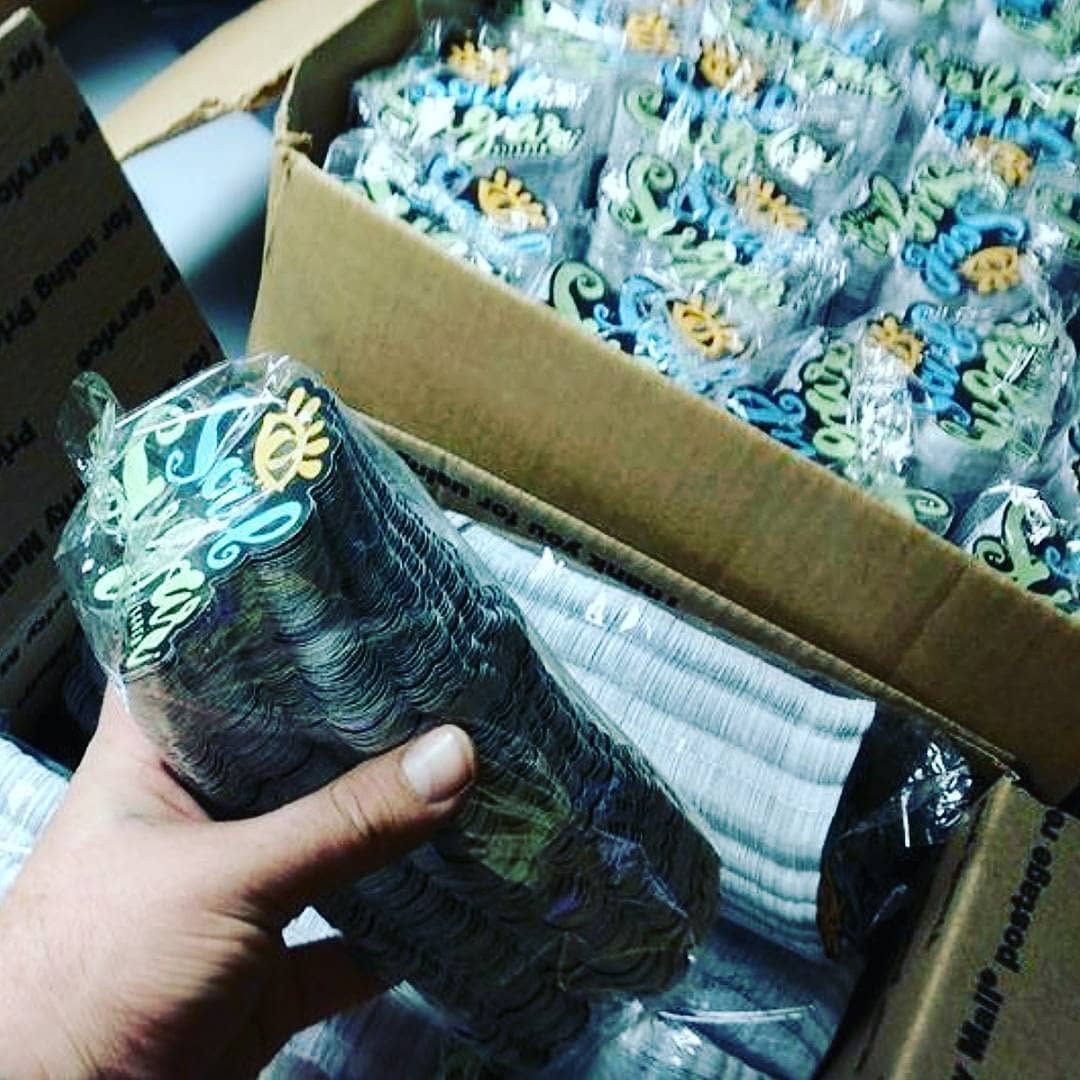 Stacks of custom die cut stickers packed in a shipping box from an early URGrafix order